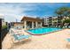Inviting community pool with lounge chairs and tables perfect for relaxation at 6070 80Th N St # 215, St Petersburg, FL 33709