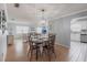 Cozy dining room with wood floors, and chandelier adjacent to a well-lit living room and kitchen at 6070 80Th N St # 215, St Petersburg, FL 33709