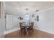 Inviting dining area features neutral walls, wood floors, and an elegant chandelier fixture at 6070 80Th N St # 215, St Petersburg, FL 33709