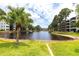Scenic pond view surrounded by lush landscaping in a peaceful community at 6070 80Th N St # 215, St Petersburg, FL 33709
