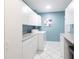 Laundry room with white cabinets and modern washer and dryer at 6070 80Th N St # 215, St Petersburg, FL 33709