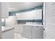 Spacious laundry room with white cabinetry and modern washer and dryer at 6070 80Th N St # 215, St Petersburg, FL 33709