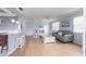 Inviting living room has hardwood flooring, neutral paint, and convenient access to kitchen bar seating at 6070 80Th N St # 215, St Petersburg, FL 33709