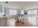 Bright living room with wood floors, neutral decor, and sliding glass doors to a private balcony at 6070 80Th N St # 215, St Petersburg, FL 33709