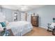 Comfortable bedroom featuring soft, relaxing colors, wood flooring, and ample closet space at 6070 80Th N St # 215, St Petersburg, FL 33709