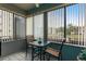 Sun room featuring a glass table, two chairs and light-filtering window shades at 6070 80Th N St # 215, St Petersburg, FL 33709