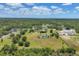 Expansive property with a home, pond, outbuildings, and scenic surroundings from an aerial view at 6242 Tropicaire Blvd, North Port, FL 34291