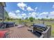 Back deck featuring a grill, hot tub and furniture with pond and green space views at 6242 Tropicaire Blvd, North Port, FL 34291