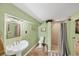 Cozy bathroom featuring a pedestal sink, neutral tile floors, and a framed shower at 6242 Tropicaire Blvd, North Port, FL 34291