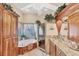 Luxurious bathroom featuring a soaking tub, glass-enclosed shower, and granite countertops at 6242 Tropicaire Blvd, North Port, FL 34291