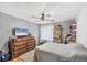 Comfortable bedroom featuring a ceiling fan and a wall-mounted cabinet for displaying collectables at 6242 Tropicaire Blvd, North Port, FL 34291