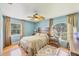 Inviting bedroom featuring hardwood floors, a comfortable bed, and ample natural light at 6242 Tropicaire Blvd, North Port, FL 34291