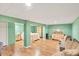 Large, light-filled bedroom with wood-look floors, large closets and ample seating area at 6242 Tropicaire Blvd, North Port, FL 34291