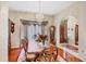 Bright dining room with hardwood floors, large windows, and an ornate chandelier at 6242 Tropicaire Blvd, North Port, FL 34291