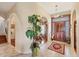 Elegant foyer with tile floors, arched doorways, wooden door with decorative glass and a grand staircase at 6242 Tropicaire Blvd, North Port, FL 34291