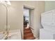 View of laundry room with washer, dryer, and sink, and a staircase leading to another room at 6242 Tropicaire Blvd, North Port, FL 34291