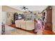 Bright living room with tile and hardwood floors, white couches, ceiling fan, and natural light at 6242 Tropicaire Blvd, North Port, FL 34291