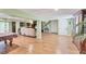 Expansive living area with tile floors, a dining table, and a cozy seating area with couches at 6242 Tropicaire Blvd, North Port, FL 34291