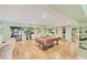 Large living area with tile floors, a pool table, comfortable couches, and a kitchenette at 6242 Tropicaire Blvd, North Port, FL 34291