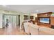 A large living area with tile floors, comfortable couches, a TV, and access to a fitness area at 6242 Tropicaire Blvd, North Port, FL 34291