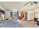 Bright main bedroom with a sitting area, ensuite bathroom, and walk-in closet at 6242 Tropicaire Blvd, North Port, FL 34291