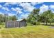 Outbuilding in large yard featuring a fenced enclosure and a secure storage area at 6242 Tropicaire Blvd, North Port, FL 34291