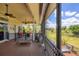 Expansive screened patio offering lovely pond views, seating, and retractable shades at 6242 Tropicaire Blvd, North Port, FL 34291