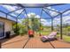 Screened patio with seating, pond view, and abundant light at 6242 Tropicaire Blvd, North Port, FL 34291