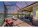 Relaxing screened patio with comfortable seating, string lights and views of the pond at 6242 Tropicaire Blvd, North Port, FL 34291