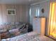 This cozy bedroom includes a floral loveseat, a dresser, and a double bed with patterned bedding for relaxation at 6832 Holo Ct, North Port, FL 34287