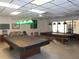 Community billiard room with two pool tables, lighting, and ceiling fan at 6832 Holo Ct, North Port, FL 34287