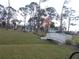 Scenic community park with lush green space, white gazebo, and charming bridge at 6832 Holo Ct, North Port, FL 34287