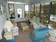 Bright lanai featuring comfortable seating, glass top table, and lots of natural light through the many windows at 6832 Holo Ct, North Port, FL 34287