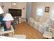 Comfortable living room with plush seating, a wall-mounted TV, and natural light at 6832 Holo Ct, North Port, FL 34287
