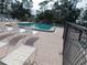 A community pool on a sunny day with lounge chairs for residents at 6832 Holo Ct, North Port, FL 34287