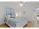 Bright bedroom with a white wooden bed frame, wood flooring, and patterned curtains at 732 Santa Margerita Ln, Punta Gorda, FL 33950