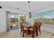 Bright dining area boasts a glass-top table, tropical-themed chairs, and sliding glass door access at 732 Santa Margerita Ln, Punta Gorda, FL 33950
