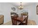 Elegant dining room features a wooden table, decorative chandelier, and bright natural light at 732 Santa Margerita Ln, Punta Gorda, FL 33950