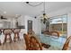 Dining area featuring rattan chairs, a glass top table and an overhead chandelier at 732 Santa Margerita Ln, Punta Gorda, FL 33950