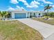 Charming home featuring a well-manicured lawn, tiled roof, and an attached two-car garage, offering comfort and style at 732 Santa Margerita Ln, Punta Gorda, FL 33950