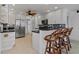 Bright kitchen features white cabinets, stainless steel appliances, and a breakfast bar with seating at 732 Santa Margerita Ln, Punta Gorda, FL 33950
