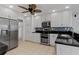 Well-lit kitchen features stainless steel appliances, white cabinets, and stylish backsplash at 732 Santa Margerita Ln, Punta Gorda, FL 33950
