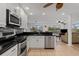 Modern kitchen with white cabinets, stainless steel appliances, and sleek black countertops at 732 Santa Margerita Ln, Punta Gorda, FL 33950