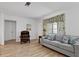 Comfortable living room featuring hardwood floors, a decorative window, and stylish furniture at 732 Santa Margerita Ln, Punta Gorda, FL 33950