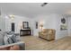 Open-concept living area with sleek hardwood floors, stylish furniture, and modern decor at 732 Santa Margerita Ln, Punta Gorda, FL 33950