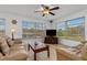 Comfortable living room with waterfront view, neutral furniture, and a ceiling fan at 732 Santa Margerita Ln, Punta Gorda, FL 33950
