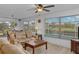 Cozy living room with canal views, neutral decor, and a ceiling fan at 732 Santa Margerita Ln, Punta Gorda, FL 33950