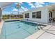Backyard pool is surrounded by a screened enclosure and sunny skies at 732 Santa Margerita Ln, Punta Gorda, FL 33950