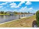 Scenic waterfront view with a dock and boat lift under a clear sky at 732 Santa Margerita Ln, Punta Gorda, FL 33950