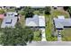 Aerial view of a well-maintained home with a metal roof, a long driveway, and green landscaping at 809 Kings Ct, Punta Gorda, FL 33950